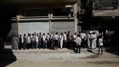 Aleppians_waiting_in_a_bread_line_during_the_Syrian_civil_war.jpg