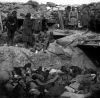 Russian_soldiers_stand_over_trench_of_dead_Japanese.jpg