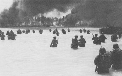 165th Infantry assault wave attacking Butaritari, Yellow Beach Two, find it slow going in the coral bottom waters. Jap machine gun fire from the right flank makes it more difficult for them. Dargis, Makin Atoll, Gilbert Islands, November 20, 1943
